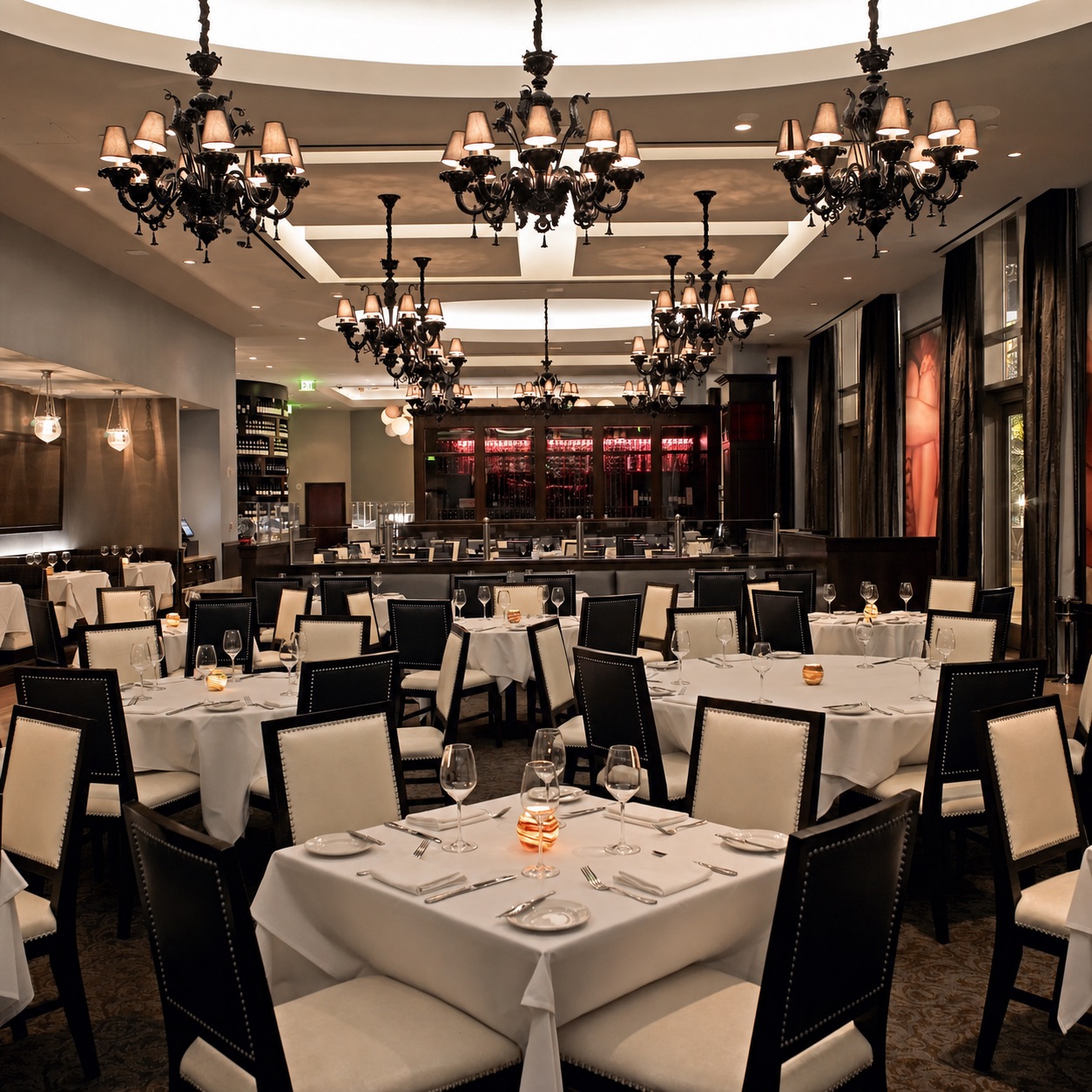 Dining room at Morels Steakhouse with repeated La Murrina chandeliers