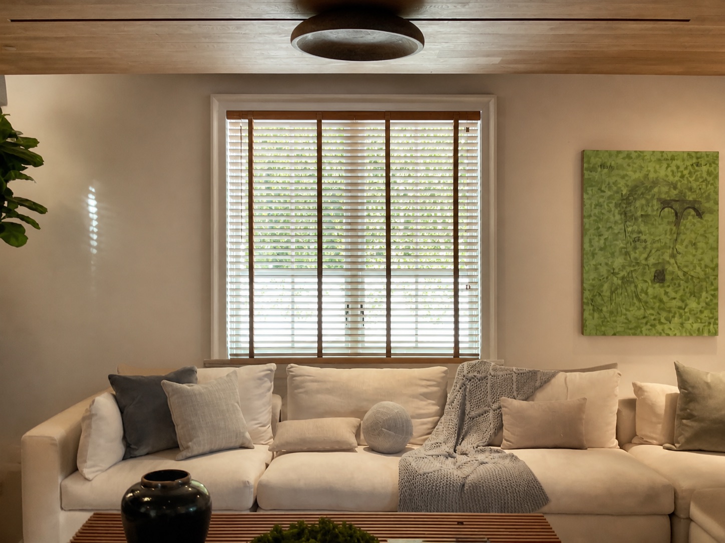 Custom two-inch wood blinds with coordinating contrast ladder tape in a contemporary residential living room